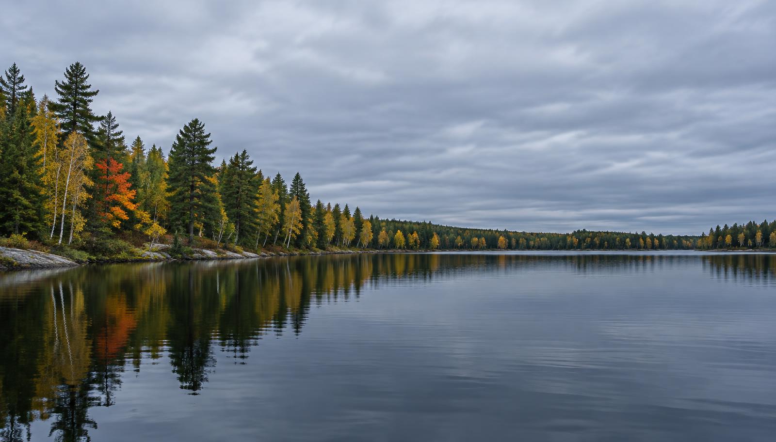 A north-woods lake reflecting an autumn shoreline